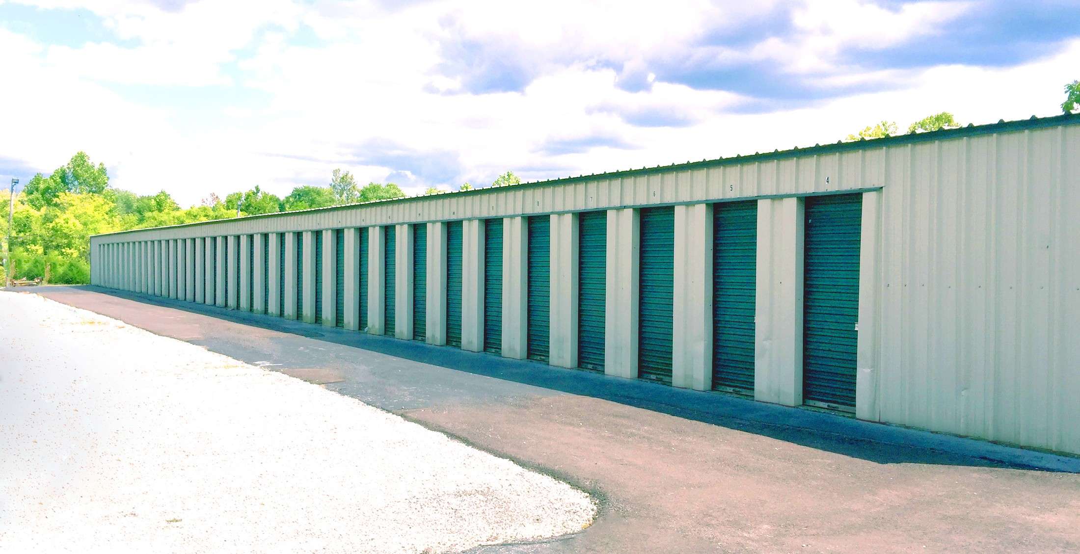 Long row of green roll-up storage doors at Jeffersonville and Clarksville Self Storage